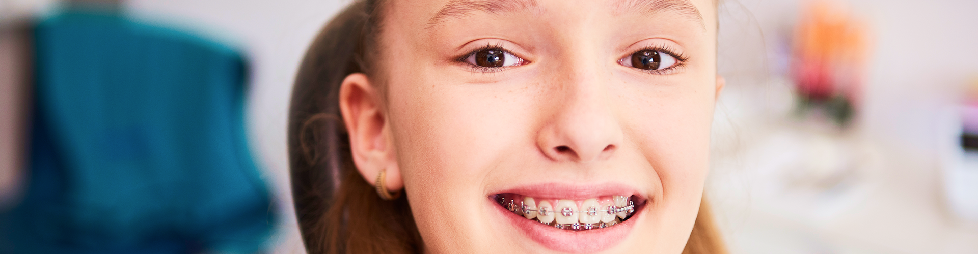 Smiling girl with braces.